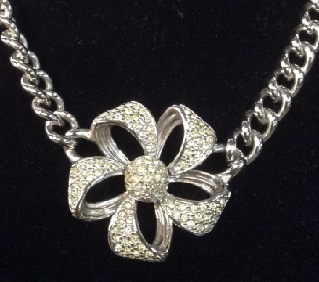Monet Siver Toned Necklace with Rhinestone Flower: Monet Silver Toned Necklace with Rhinestone Flower, Signed Monet on Clasp, 15 in length, Curb chain link, pendant 11/2 diameter, box Closure, good condition, Monet Jewelry, Ladies Designer Costume, Si