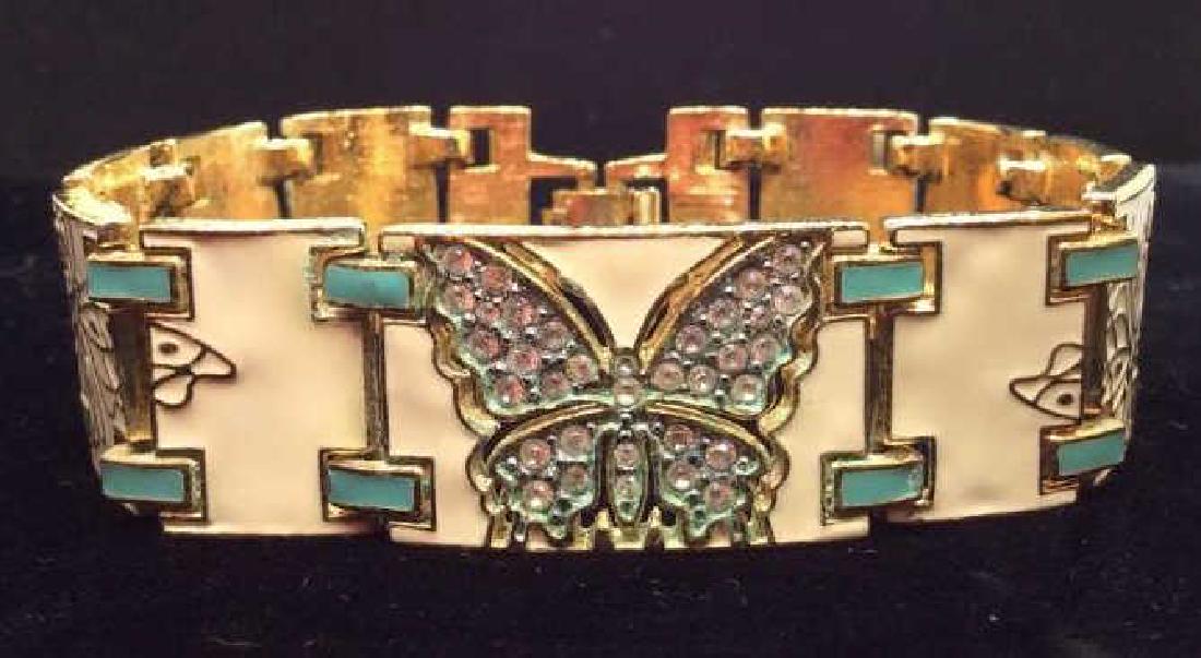 BOB MACKIE Enamel Butterfly Bracelet: BOB MACKIE Enamel Butterfly Bracelet. Rectangular link bracelet, gold toned metal with beige and turquoise toned enamel details, rhinestone butterfly design. Measures approx 3 in in diameter. Women’