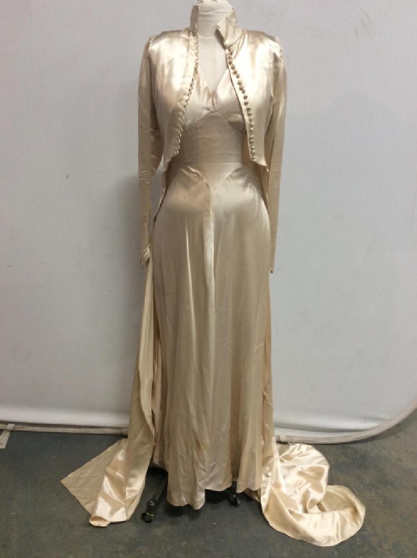 Vintage Women’s Bridal Gown W Top Blazer: Vintage women’s Evening / wedding / bridal gown / dress with top coat / blazer with extra long train. Fabric is cream in tone and possibly lightweight satin. Both dress and coat have stains, and som