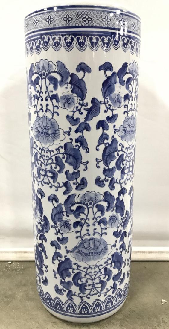 Asian Porcelain Umbrella Holder: Piece is white and blue toned. Contains intricate floral vine and leaf detail. Measures approx 24 inches tall 9 inches diameter. 6