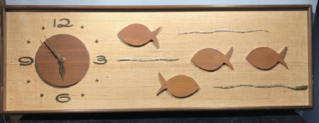 Vintage Wood Carved Deco Fish Wall Clock: Vintage wood carved deco fish wall clock. Possibly handmade, artisan made. Clock features a simple wood clock with brass hands and numbers, attached to the left of a board backing with wooden fish det