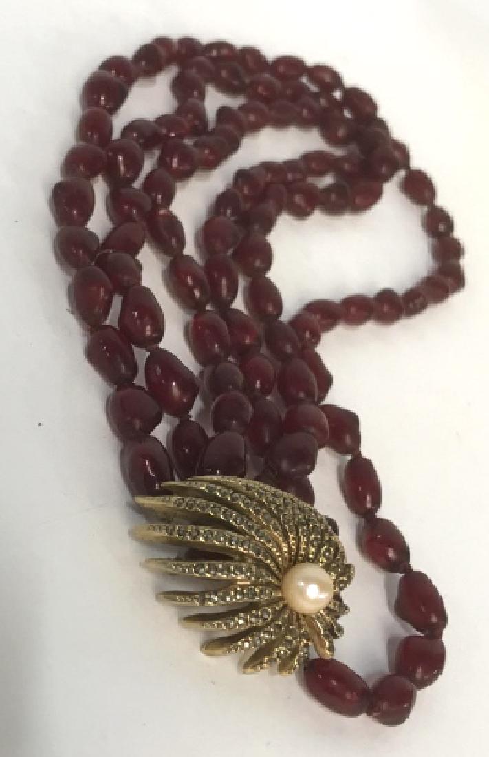 Vintage Multi Strand Crimson Necklace w Jeweled: Clasp , multi strand necklace of crimson beads, decorative gold sunburst claw clasp w center pearl, , clasped measures 8 inches to lowest drop, Signed on Clasp, Les Bernard Inc, Signed jewelry, estate