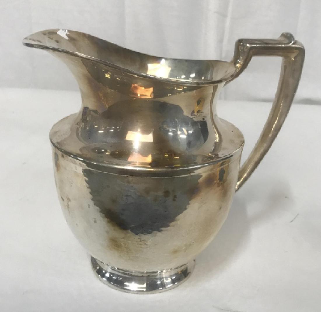 Trademarked Hand Hammered Silver Pitcher: Pitcher, vase, Vessel, silver table ware, marked underside for 965, MERIDEN, S P C O, International S Co, hand hammered, measures app ht 8 inches length handle to spout 9 inches depth app 7 inches