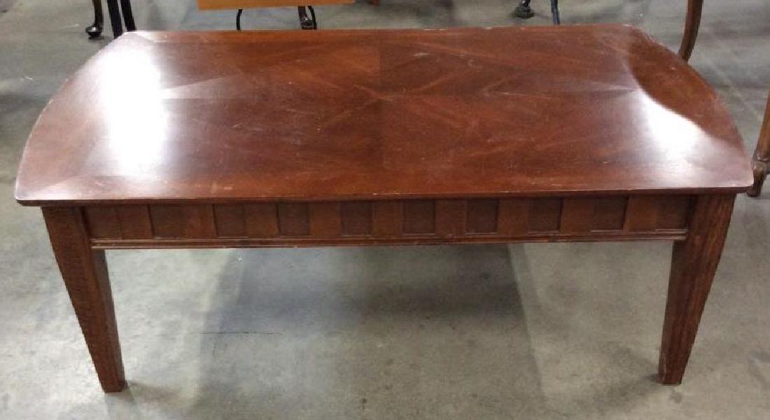 Brown toned Coffee Table: Brown toned Coffee Table. Low wooden coffee table, some scratches and nicks to surface. Home furnishings, coffee table, living room furniture. Measures approx 17 in by 48 in by 28 in. 4