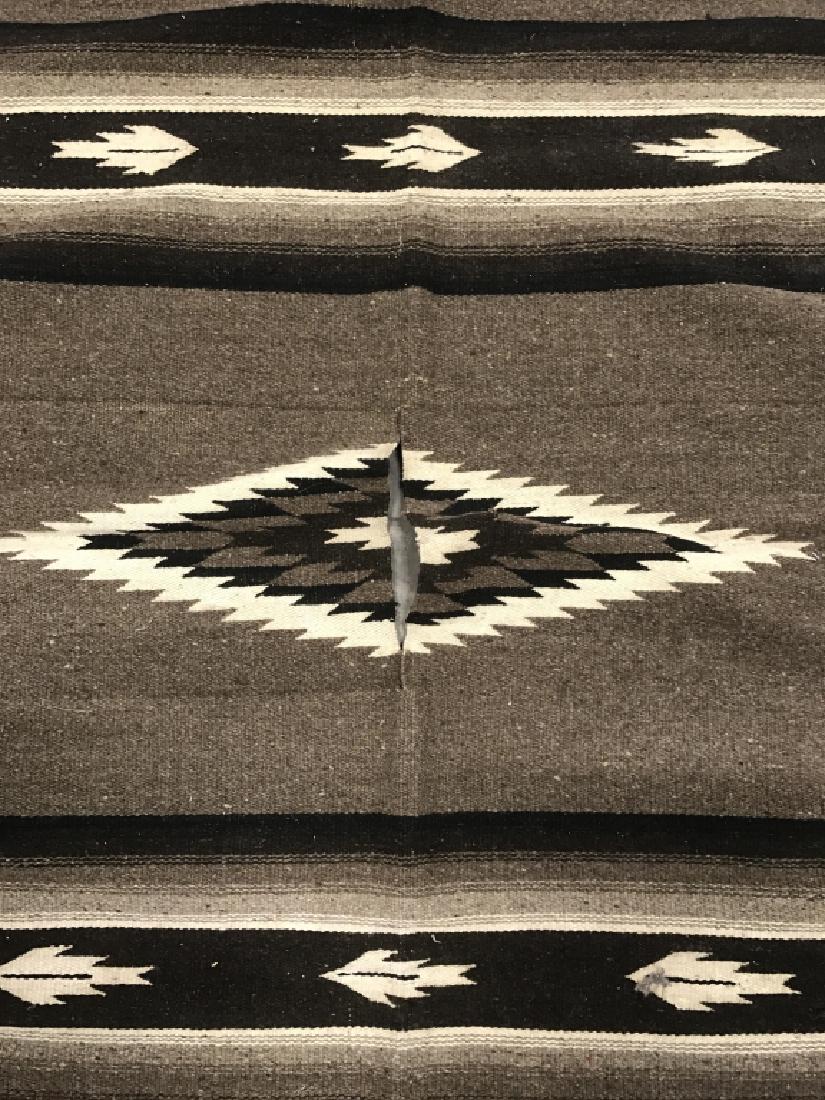 Vintage 1920s Navajo Woven Wool Rug / Poncho: Vintage Navajo Native American wool rug or serape / cloak / poncho. Rug is multicolor brown and beige in tone with a slit in the center for the head in order to be worn as a poncho. Piece measures app