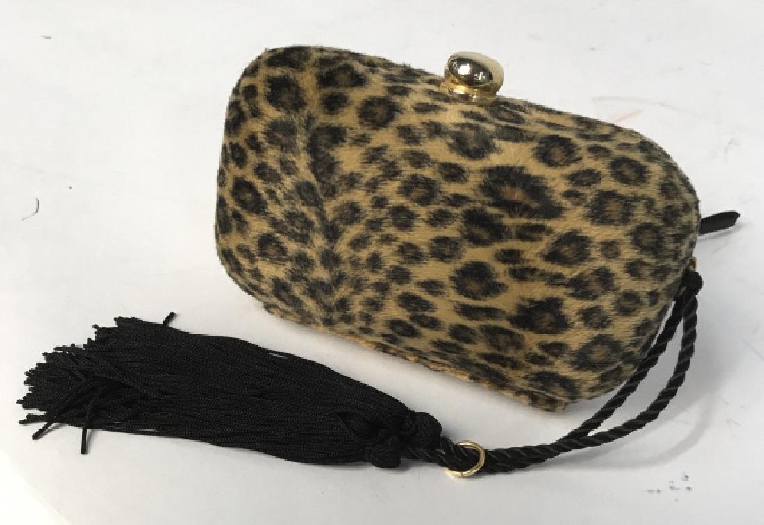 Fuzzy Leopard Fur Clutch Purse: Fuzzy fur or plush exterior on hard case with gold toned clasp and black tassel detailing, print of leopard pattern, measures app 6 by 4 inches, fashion accessory, hand bag clutch