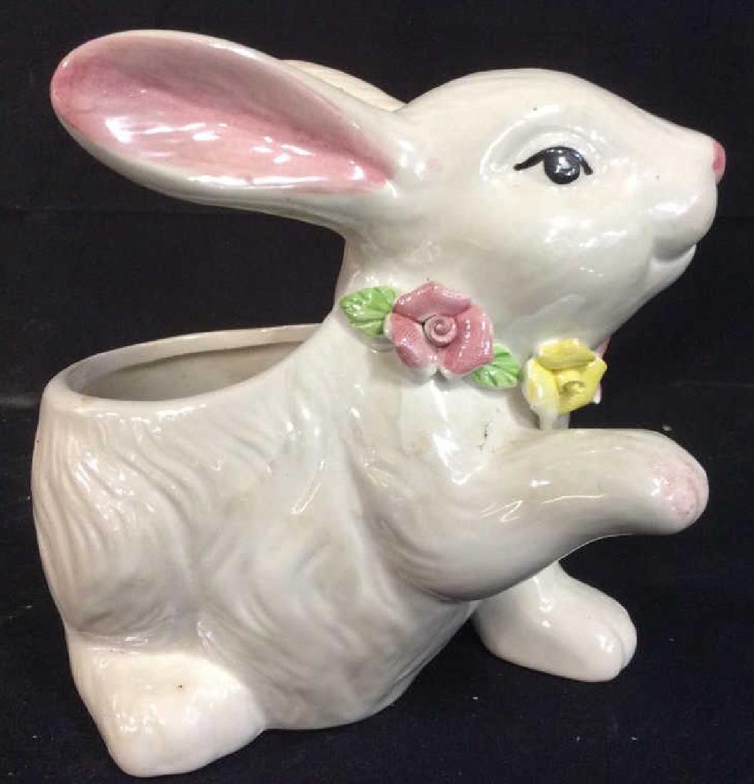 BLOOM RITE Garden Bunny Figural Planter: BLOOM RITE Garden Bunny Figural Planter. White tone planter vase with added floral details, some minor surface wear, cleaning needed. Marked on underside for BLOOM RITE. Measures approx 7 in by 7 in b