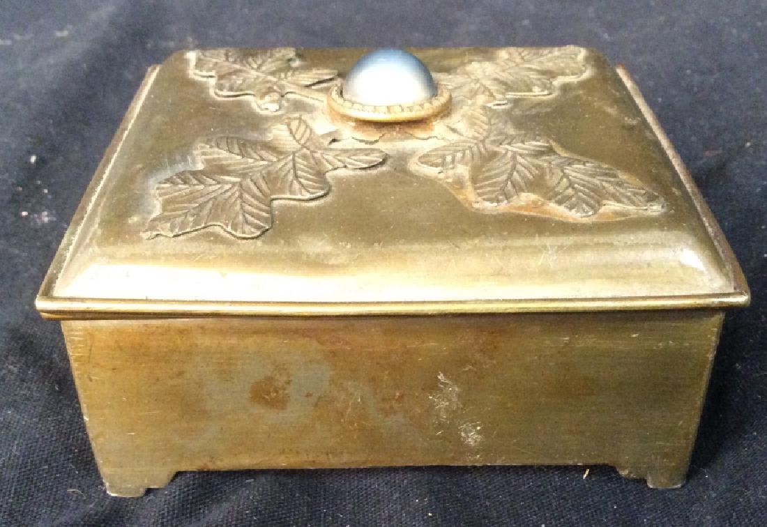 Vintage/Antique keepsake Box: Trinket Box is vintage possibly antique. Appears to Possibly be brass. Piece is gold toned. Has faux stone on top of lid. Has evident wear and some warping. Measures app 3.5 inches long 3 inches deep 