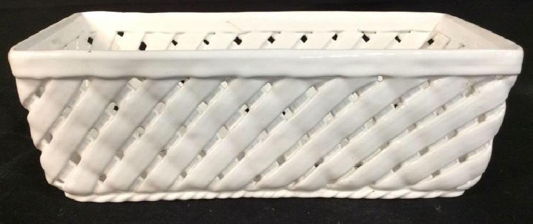 White Toned Porcelain Planter: Planter holder is rectangular. Has woven style structure. Planter holder, planter vessel, porcelain planter holder. Measures app 13 inches long 6 inches deep 4 inches tall. Piece is signed on undersid