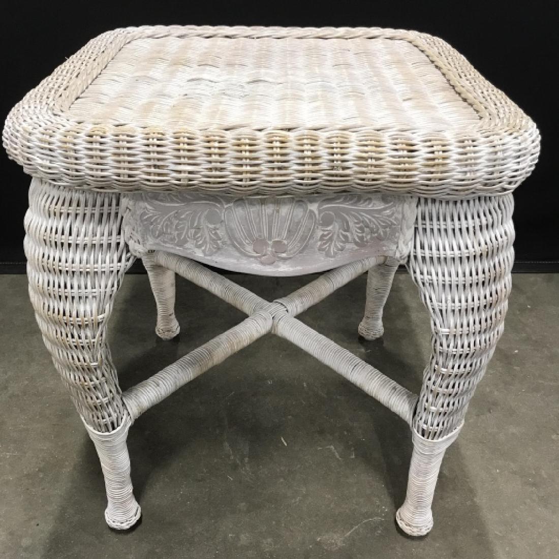 Country Chic Wicker Side Table: Country chic woven wicker side table. Wicker is rustic brushed white in tone. Table has carved shell and leaf details on Board frame under tabletop. Measures approx 22 inches in height by 20 inches sq