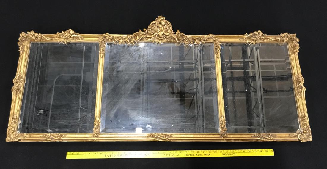 Hickory Manor House Georgian Style Mantle Mirror: Hickory Manor House Georgian Style Mantle Mirror with antique gold tone wood frame. Triptych mirror has beveled mirrors and floral details in wood frame. Measures approx 54 inches in width by 24 inche