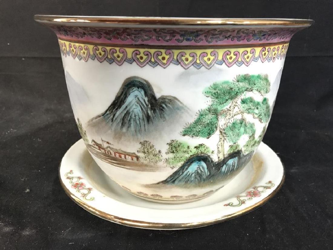 Lot 2 Asian Porcelain Planters, Signed: Lot includes porcelain planter and coaster. Piece has painted detail of mountain, trees, flowers and a village. Contains gold toned accent detail on rim. Measures approx 6 inches tall 9 inches wide. P