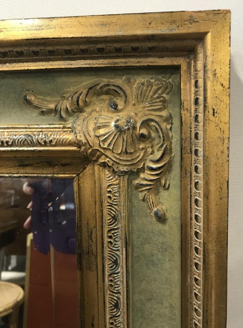 Beveled Mantle Mirror W Ornate Wood Frame: Beveled Mantle mirror with ornate carved wood frame. Frame is gold and mint green in tone. Mirror measures approx 44.5 inches in height by 32.5 inches in width by 2 inches in depth. Antique style mirr