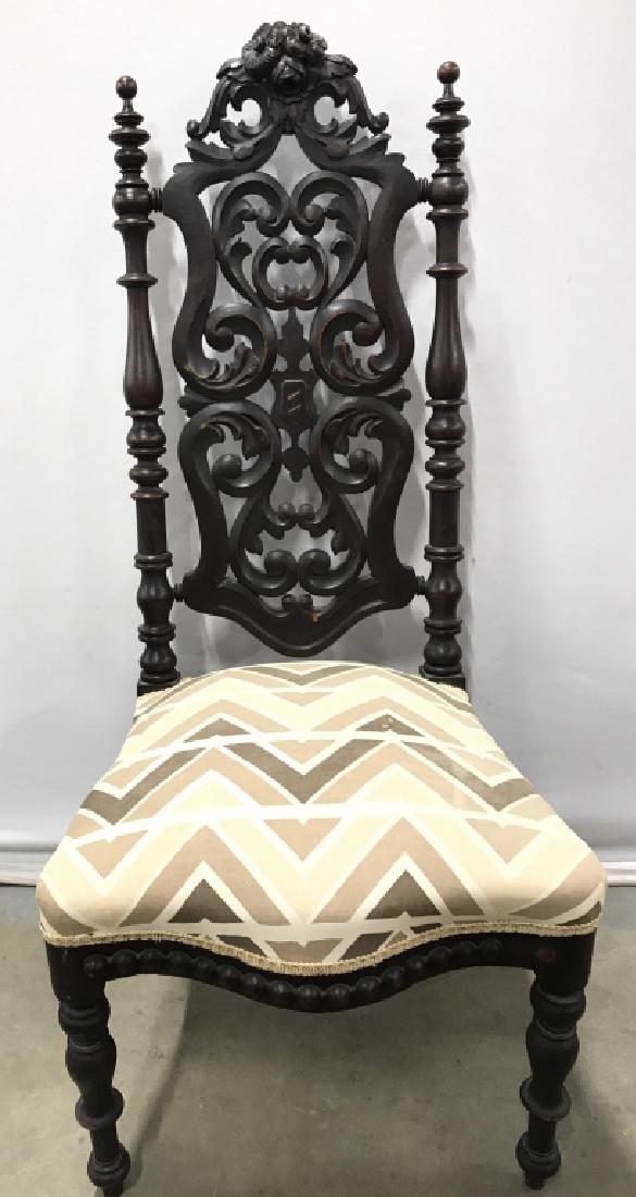 Intricately Carved Wooden Upholstered Side Chair: Vintage Carved chair in baroque style, Spanish style, Gothic style, Backrest Of Chair has intricately carved wooden detail with c & s curve detail. Chair cushion is upholstered with cream, tan, & brow