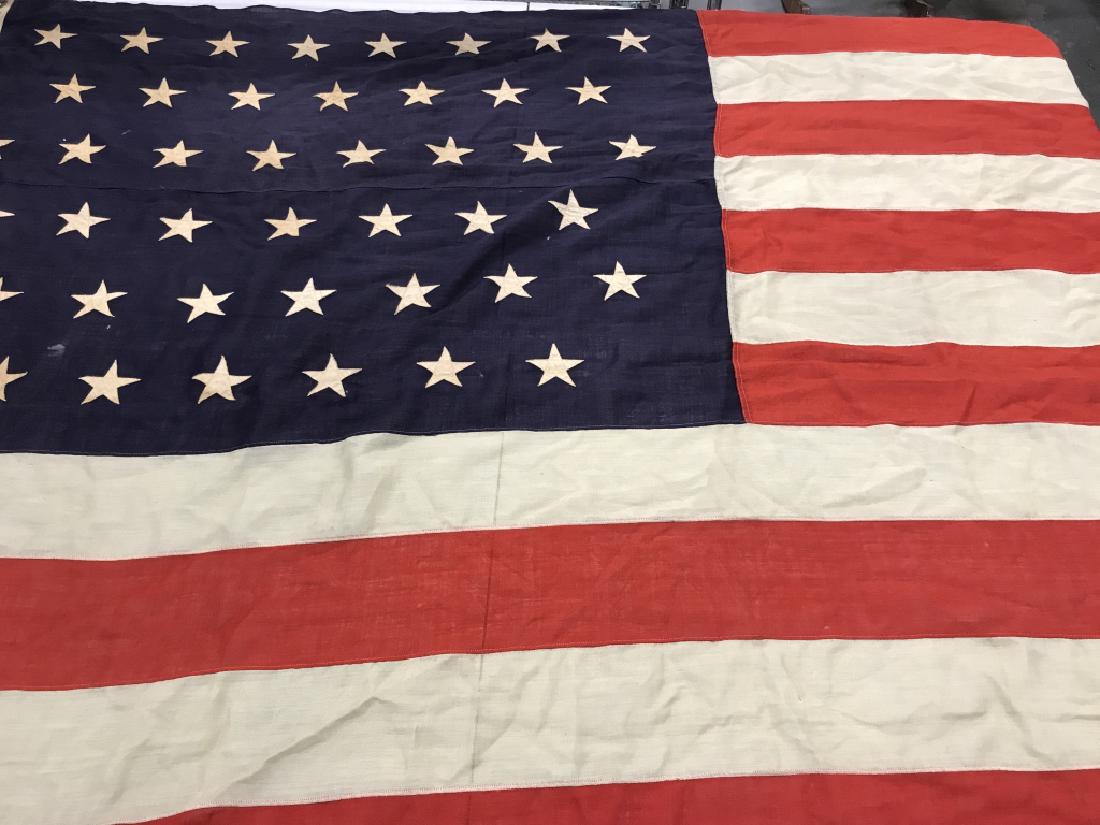 Antique Large-Scale 45 Star US Flag, Utah, c. 1896: Antique large-scale United States of America flag with 45 stars, c. 1896. Flag is composed of linen with each star hand sewn. Writing in Corner of flag reads ‘H.R. Miller.’ Some discoloration of f