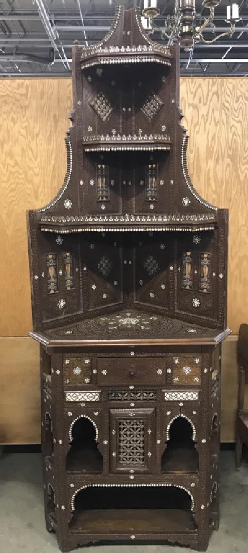 20th C Hispano-Moresque Ornate Corner Cabinet: Ornately carned corner cabinet, 20th century Hispano-Moresque style Corner Cabinet, Etergier, Ornate overall complex carved surface with mother of pearl inlay in rosettes, medallions, foliate borders 