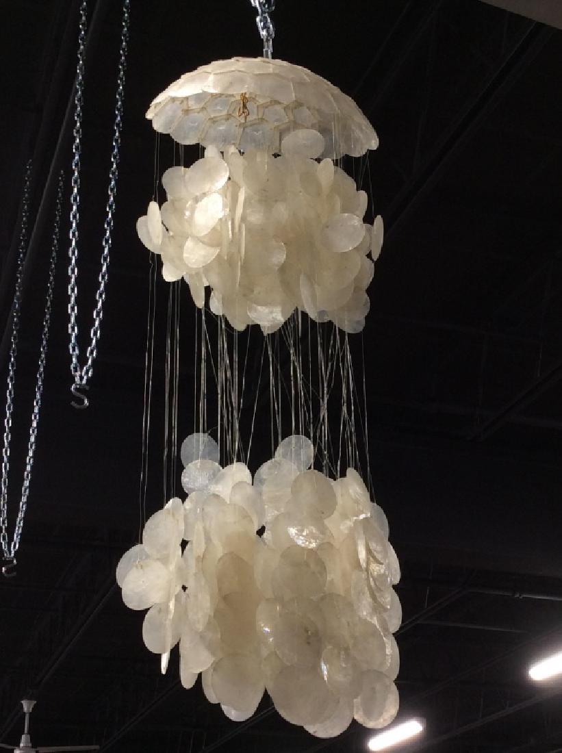 Mid Century Cascading Capiz Shell Chandelier: Mid Century Modern, 1970s Style cascading capiz Shell Chandelier. Chandelier measures approx 34 inches in length by 13 inches in diameter. Lamp socket and cord will need reaffixing. Has not been teste