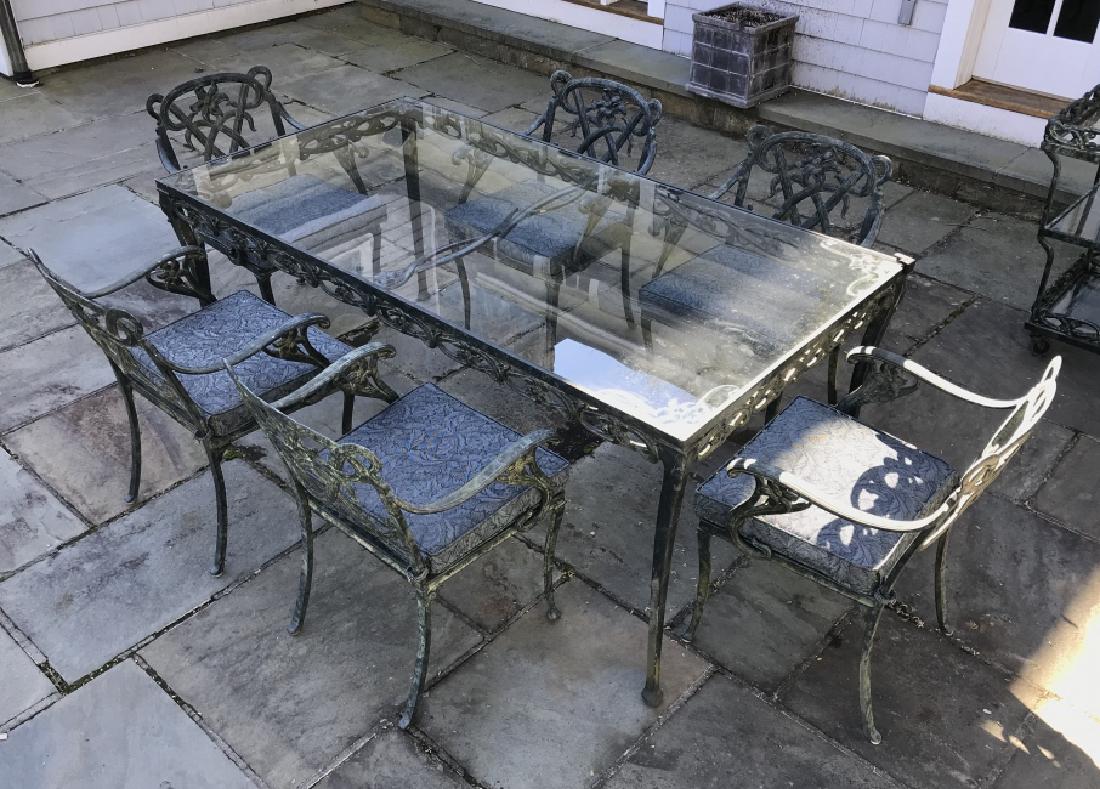 Lot 7 BROWN JORDAN Outdoor Dining Furniture Set: All labeled for Brown Jordan, Lot includes 1 Metal table with glass top 6 metal chairs, each with a cushion Table measures approx 71 inches long 30 inches tall, 37 inches deep. Label reads BROWN JORDA