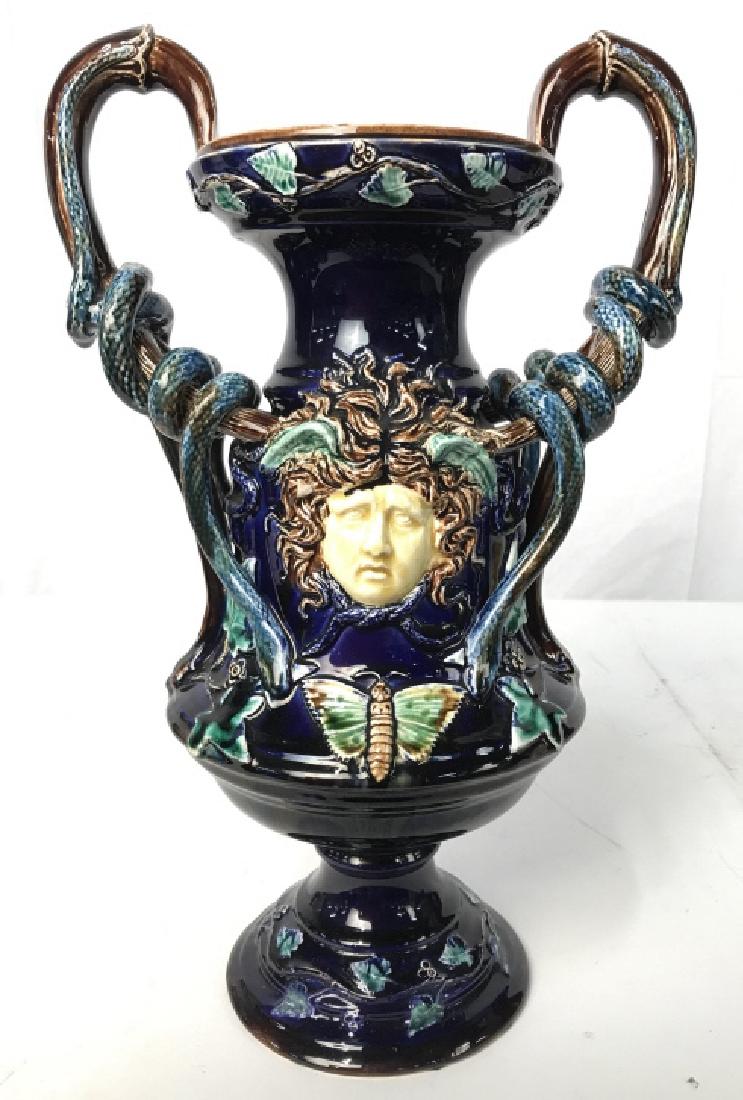 Signed Antique Medusa Majolica Ceramic Vase: Jug handled vase, trophy vase form with Medusa head medallions in relief, coiled snake forms around handles, butterflies, vines and more, richly glazed, Signed illegibly underside and dated 1874, anti