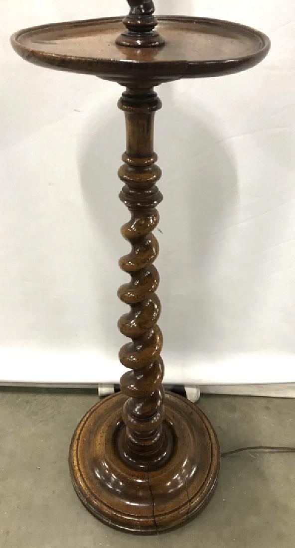 Carved Wooden Floor Lamp: Base of lamp has carved wooden detail. With small platform, drinks table, end table / lamp Top half has Candlestick style structure. Measures approx 54 inches tall 12 inches wide. Contains 2 bulb sock