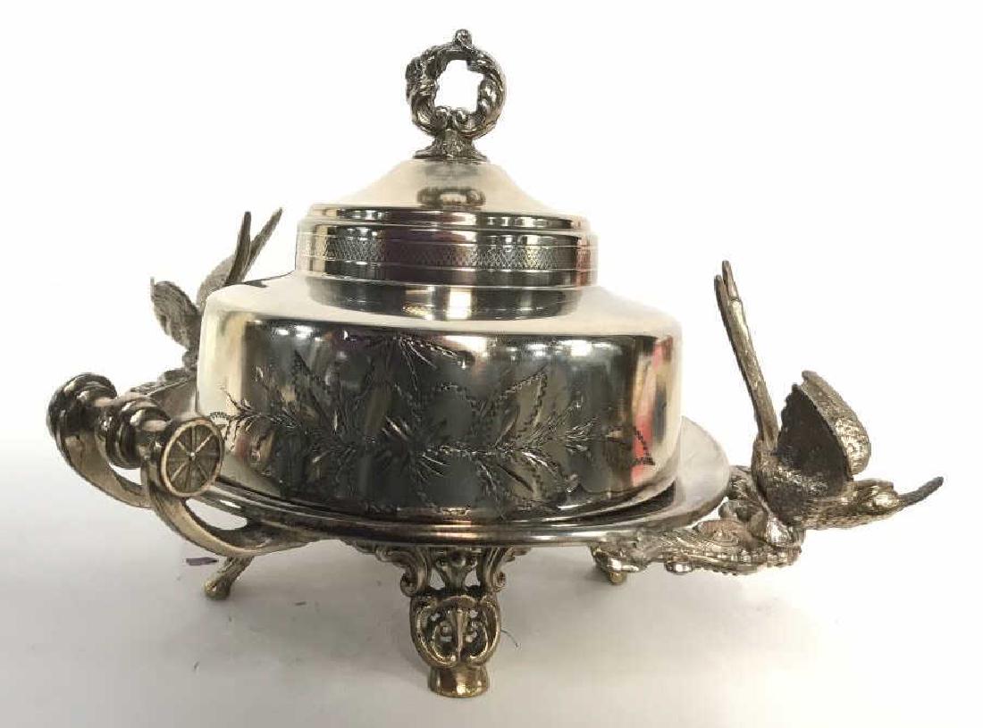 Empire Silver Bird Bath Covered Platter: Underside reads Empire Mfg Co, quadruple plate, silver serving dish, raised on four scrolled feet, has two birds and scrolled handles mounted figurals, Lid has deeply etched floral with vine pattern ,