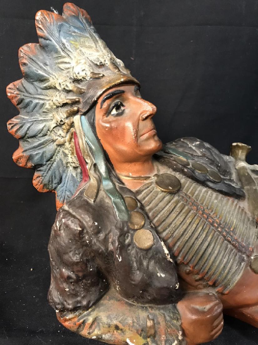 Chalkware Reclining Indian Chief Figural: Figural depicts a Native American Figure reclining. Figural has sash which reads OHIO. Figure has head dress. Measures approx 24 inches long 12 inches tall 8 inches deep. Indian Chief Figural, Native 