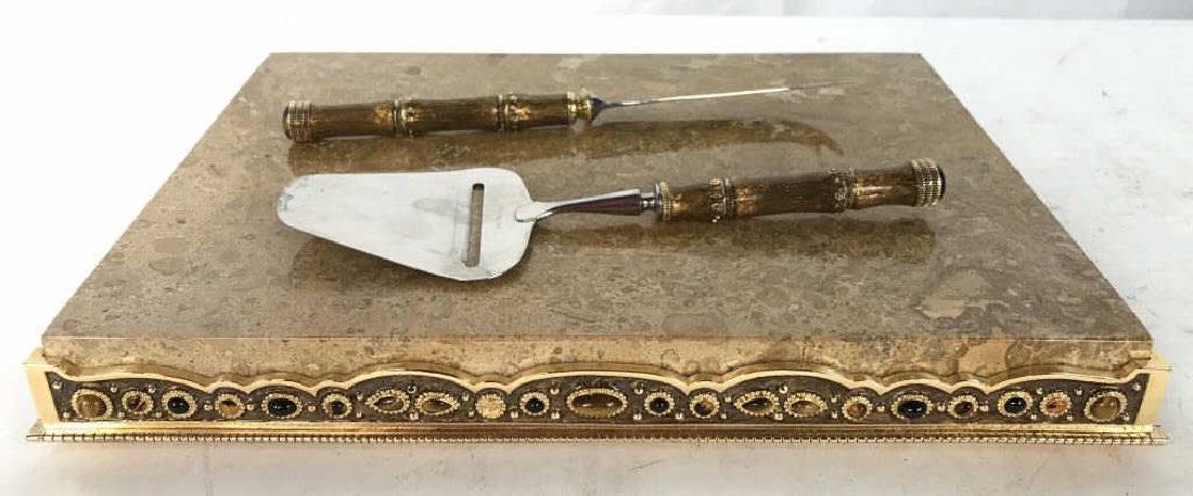 Marble & Jeweled Brass Cutting Board W Servers: Piece is Possibly MAITLAND SMITH. Contains beige toned marble top 1 knife, & 1 spatula slicer. Board measures approx 13 inhces long 10 inhces wide. Centerpiece, cheese board, tableware, some missing c
