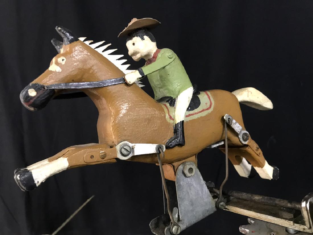 Antique Folk Art Whirligig Man Riding Horse: Hand Made Antique Folk Art Whirligig Man Riding Horse On Stand, Hand Painted Wood And Metal Parts, needs tightening on mechanical parts, has some small chips to paint, measures approximately 52 inches