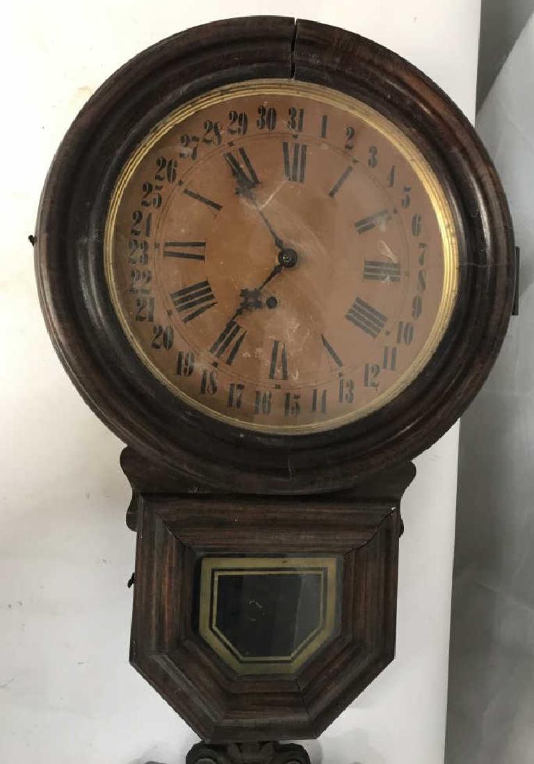 Antique E. INGRAHAM & Co Wall Clock W Tin Wall Art: Vintage, possibly antique, E. INGRAHAM & Sons wall clock with pressed metal, possibly tin wall art of harvest foliage. Dark tone wood frame on clock. Clock labeled in interior for E. Ingraham & Sons.