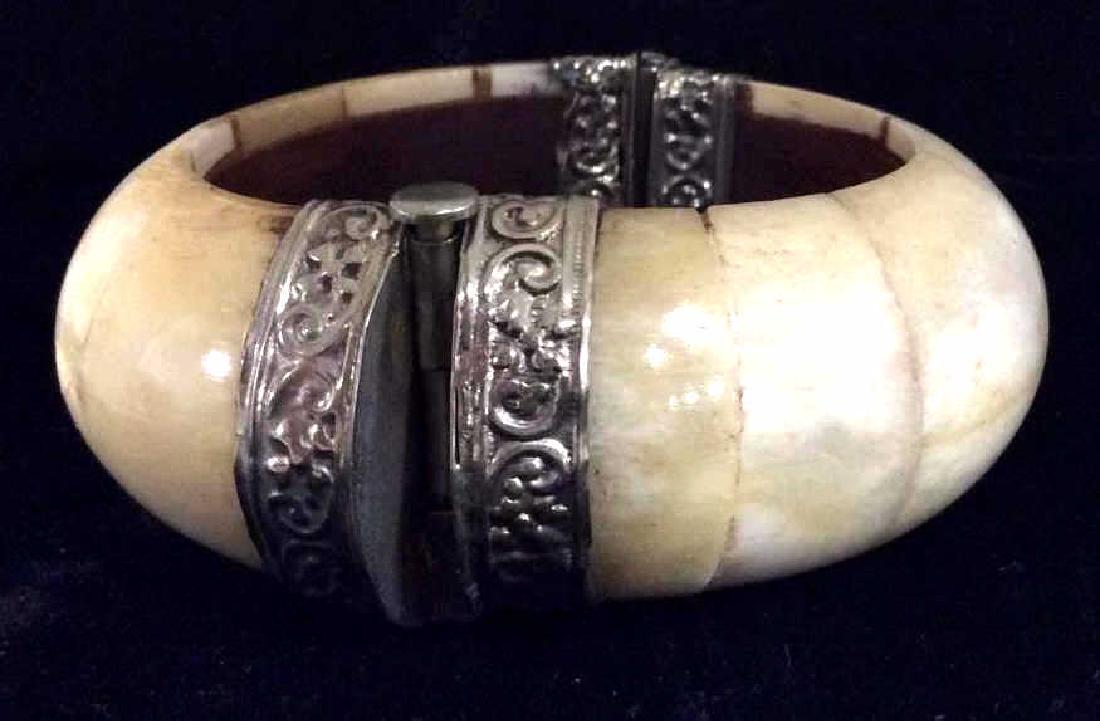 Bone Tile Bangle Bracelet: Bone tile Bangle Bracelet, thick rounded bone pieces, silver toned metal with repousse style filigree design, some discoloring and minor surface wear. Measures app 3 1/2 in in diameter. Women’s vint