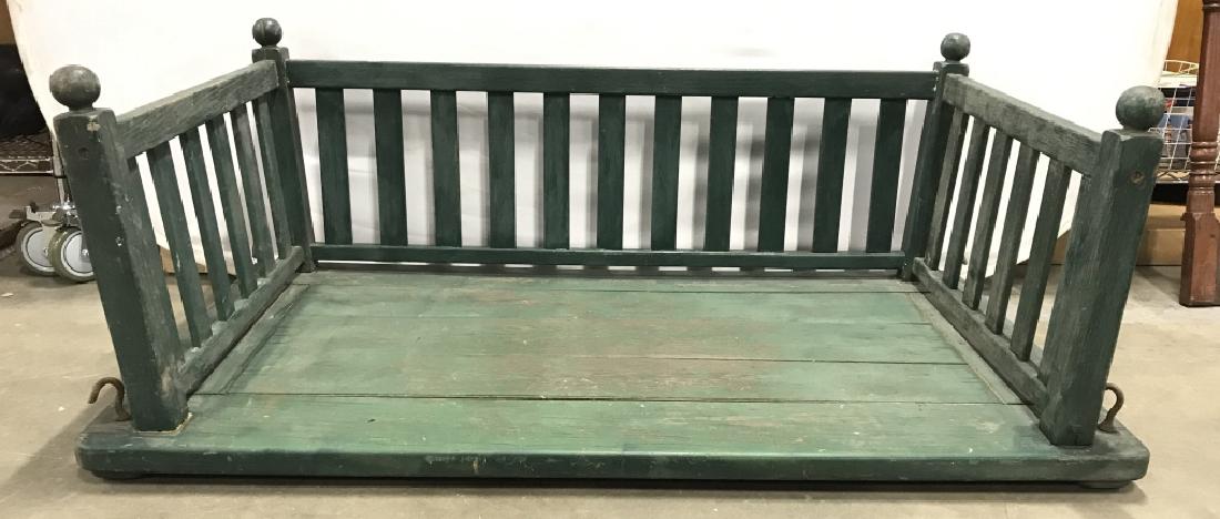 Vintage Outdoor Hanging Wooden Tree Bench: Bench is wooden and green toned. Bench has metal hooks for attachment to rope or chain. Top of bench has carved spherical shapes. Piece is vintage. Measures approx 57 inches long 32 inches deep 22 inc