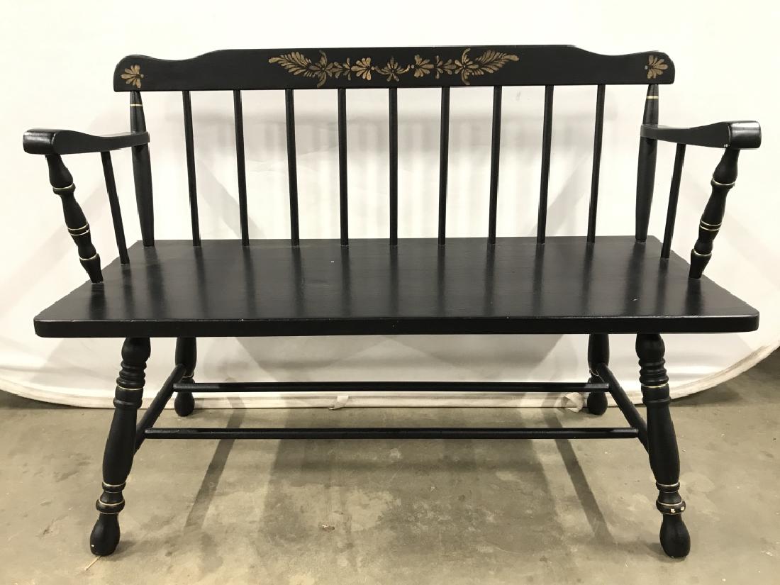 Black & Gold Toned Wooden Bench: Bench is black toned and wooden. Has spindle like back rest. Contains painted gold toned accent detail. Top of back rest has painted floral & leaf detail. Contains carved wooden detail. Piece has back