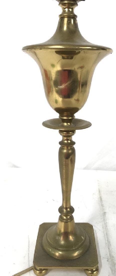 Gold Toned Brass Table Lamp: Table lamp is gold toned & brass. Lamp includes finial. Lamp has 4 feet. Measures approx 27 inches tall 4.5 inches wide. Home accent, home lighting, lighting accessory, table lamp 6.