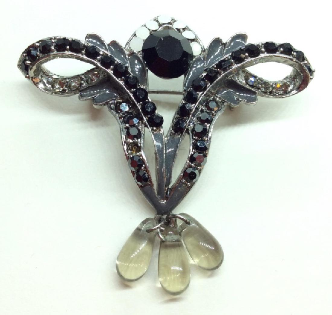 Rhinestone And Enamel Brooch Pin: Rhinestone and Enamel brooch pin, silver toned metal pin with black toned Marcasite style rhinestone details, grey toned enamel and hanging beads. measures app 2 in long . One missing rhinestone, Wome