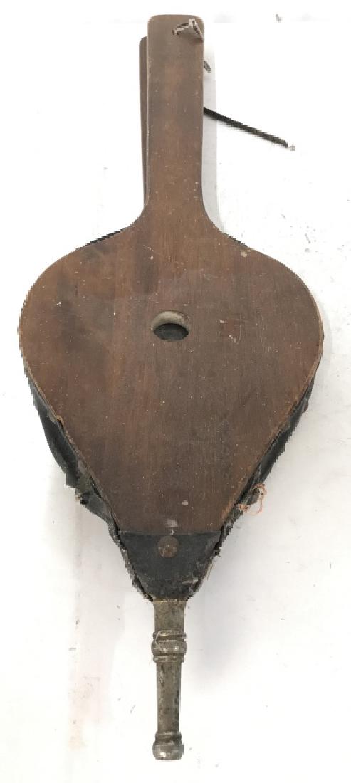 Vintage Wooden & Leather Fireplace Blower: Fireplace blower is wooden and possibly genuine leather. Piece is brown toned with silver tone metal tip. Measures approx 24.5 inches long 8 inches wide. Has evident wear. Air sack needs repair. Firep