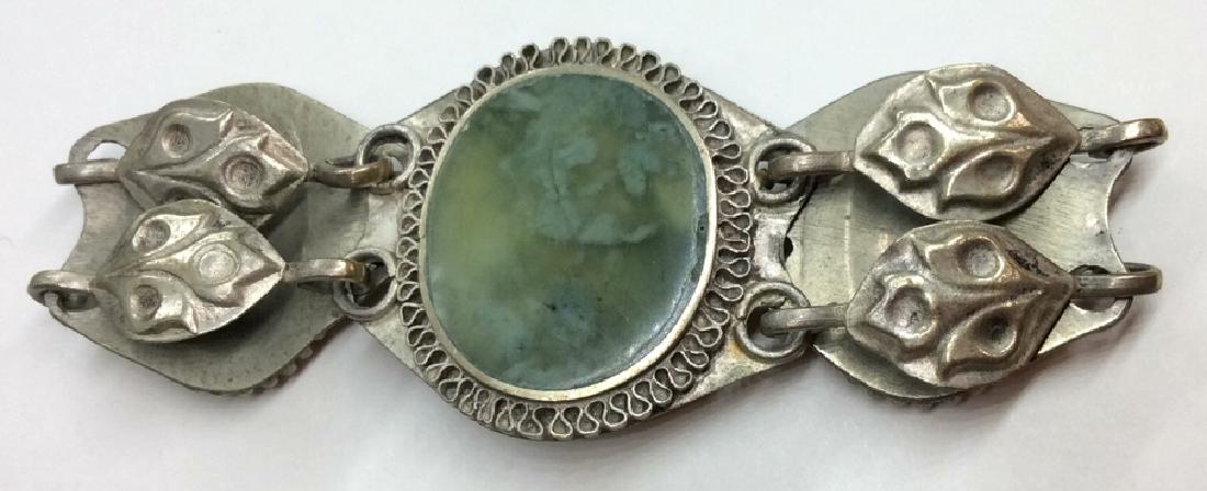 Women’s Vintage Silver Toned bracelet: Silver toned metal, hammered style design, leaf motif, green toned center details, POSs natural Stone POSs imitation material. measures app 3in in diameter . Women’s vintage estate jewelry, statemen