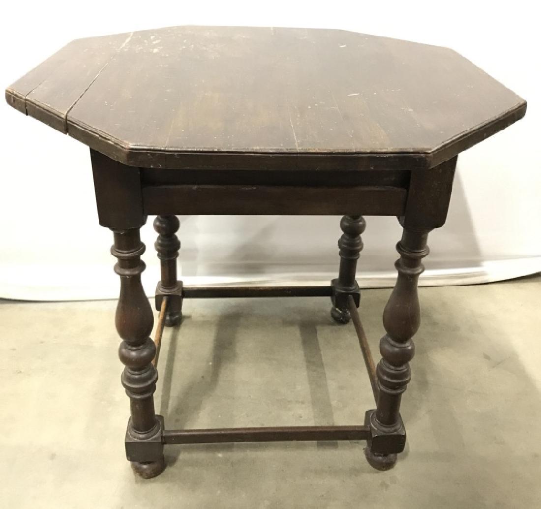 Vintage Carved Wooden Octagonal Table: Table is wooden appears to be vintage possibly antique. Tabletop is octagonal shaped. Contains 4 legs with carved wooden detail. Measures approx 24 inches tall 25 inches wide. Contains some scratches