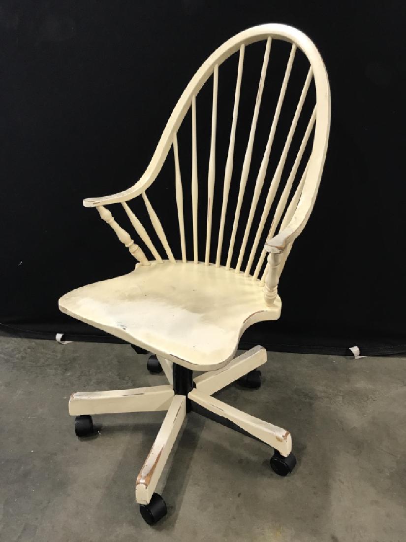 Swivel Windsor Style Office Chair: Tilting Swivel office arm chair in Windsor chair style. Chair is wood. Chair is rustic cream in tone. Some surface wear of chair. Measures approx 41 inches in height by 19 inches in width by 24 inches