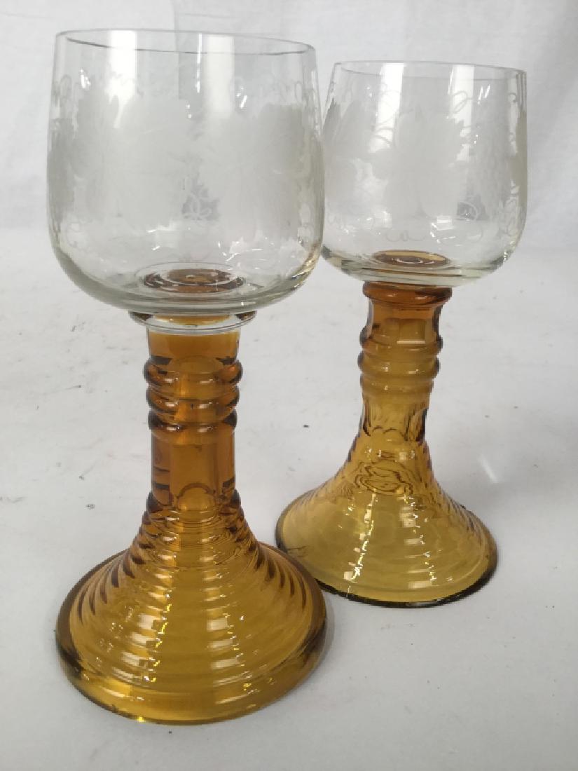 Pair Etched Bohemian Glass Goblets: Lower portion hand formed rings in Carmel Toned Glass, cups frosted etched grapes and vine patter, each measures ht app 6.5 inches, Tableware,Bar ware, wine glasses, table accents, one glass has rim c