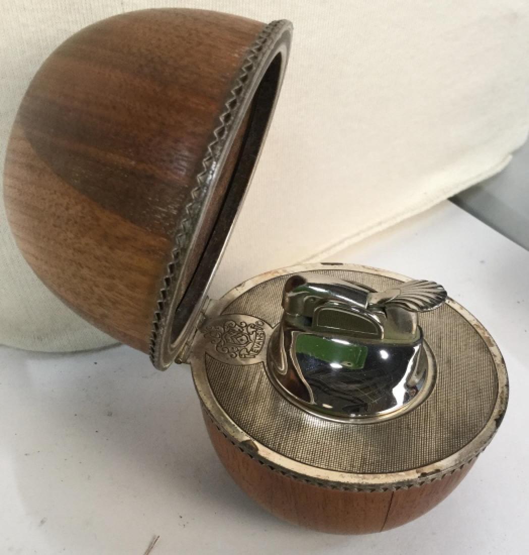 Wood Egg Encased Lighter: Wood egg form with hinged lid opens to reveal lighter marked EVANS, with emblem, desk accessory, measures ht app 4 inches diameter app 3 inches