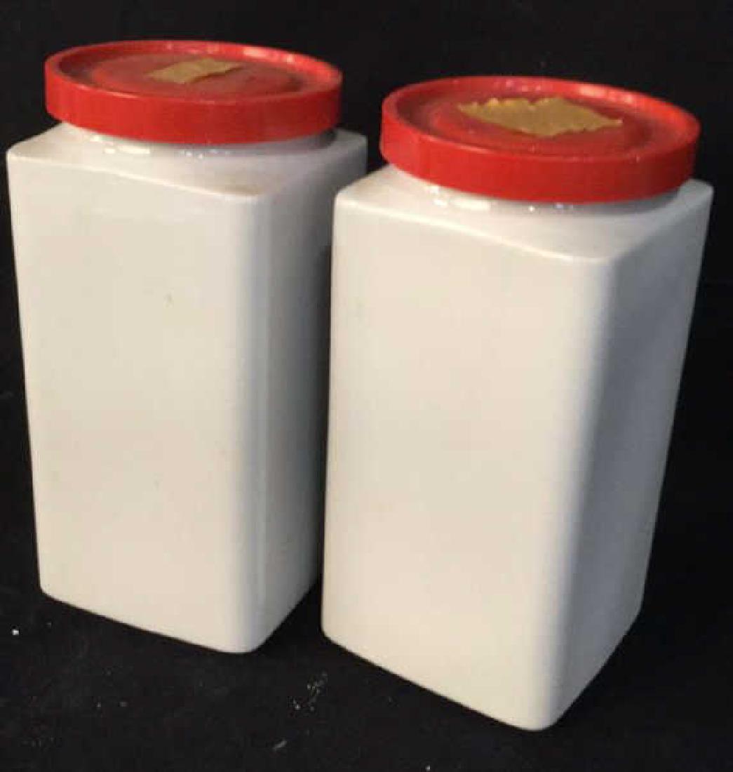 ARABIA Kitchen Countertop Cannisters, Finland: ARABIA Kitchen Countertop Canisters, Finland. White toned porcelain canister Jars with red toned composite lids. Measures approx 8 in By 4 in By 4 in. Kitchen accessory, food storage, Tableware, 4