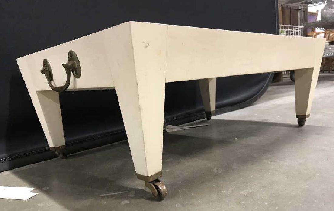 Carved Wooden Wheeled Tray: Tray is cream toned with gold toned wheels, possibly brass. Piece has 2 gold toned metal handles. Measures approx 27 inches long 17 inches deep 10 tall. Tray, drinks cart, serving table, home furnishi