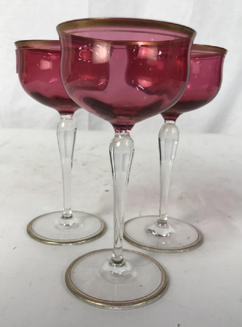 Set 3 Gold Trimmed Cranberry Glass Goblets: Cranberry glass and gold rimmed stemware set of three each measures app 6 inches ht, diameter app 3 inches, bar ware, drinking vessels, stemware, codial glasses, wine goblets