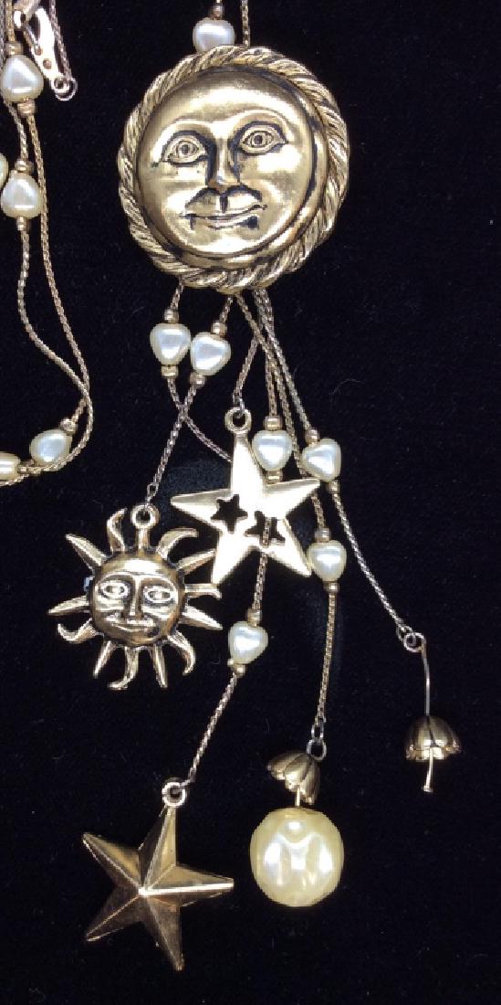 Statement Necklace W Sun, Moon, Star Charms: Statement Necklace W Sun, Moon, Star Charms, gold toned necklace with pearl style beads, possibly genuine pearls, and hanging charms. Appears to be missing a charm, statement necklace measures approx 