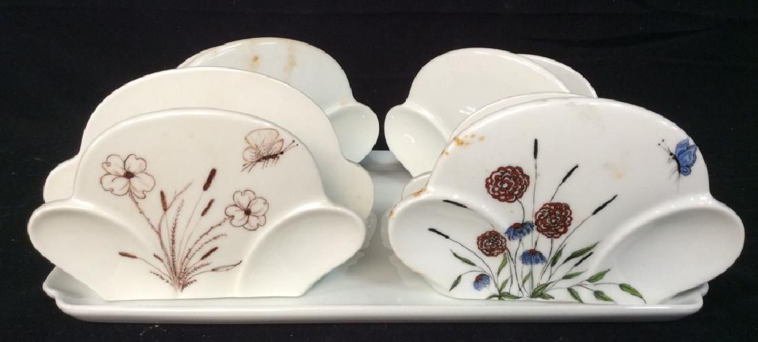 Lot 5 LIMOGES Napkin Holders & Tray: Lot 5 LIMOGES Napkin Holders And Tray. Includes 4 Napkin Holders and 1 Plate Tray. Two Napkin holders have floral design. All pieces marked for Limoges France. Tray measures approx 11.25 inches by 8.2