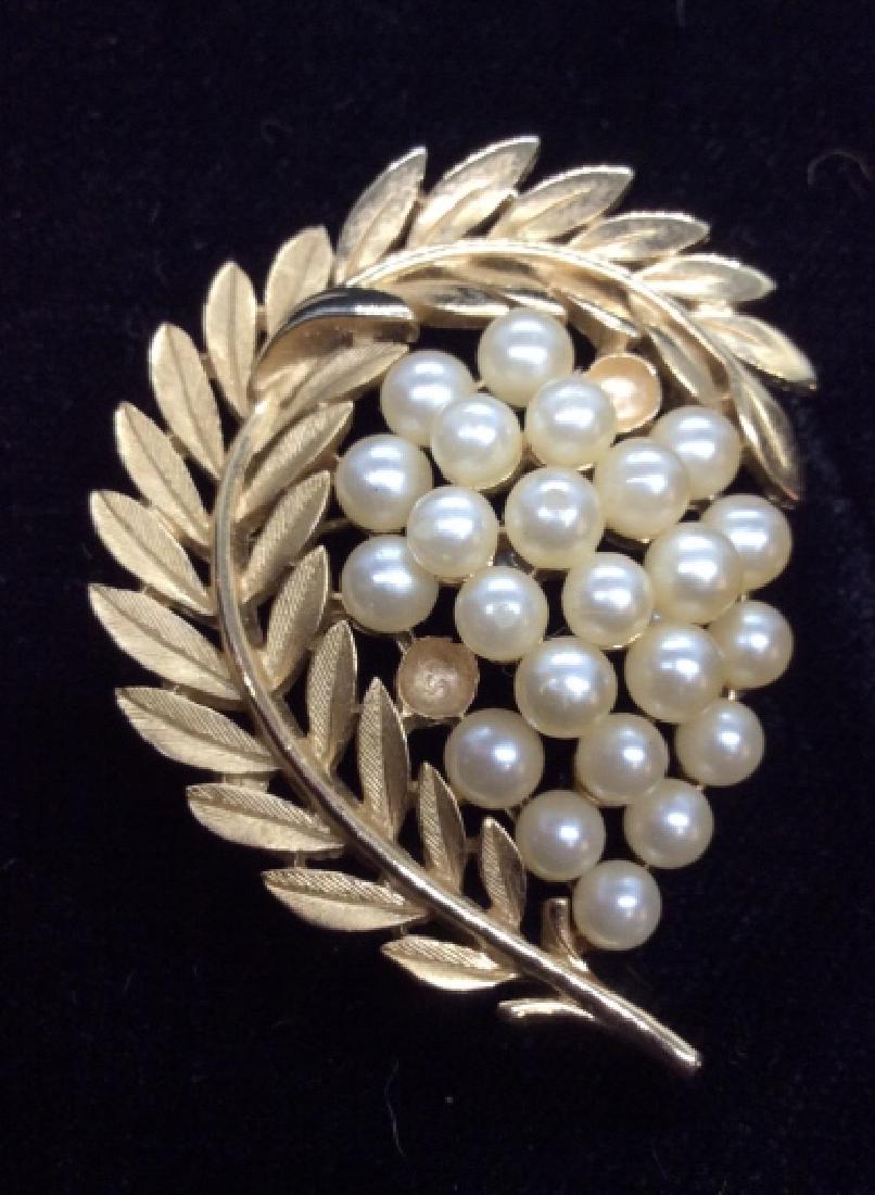 TRIFARI Costume Brooch Pin, Pearl Style Details: Gold toned metal curled leaf design pin, signed on reverse TRIFARI, with pearl style details. Women’s Costume Jewelry, missing two pearl style beads as photographed, measures app 2 in by 2 1/2 in lo