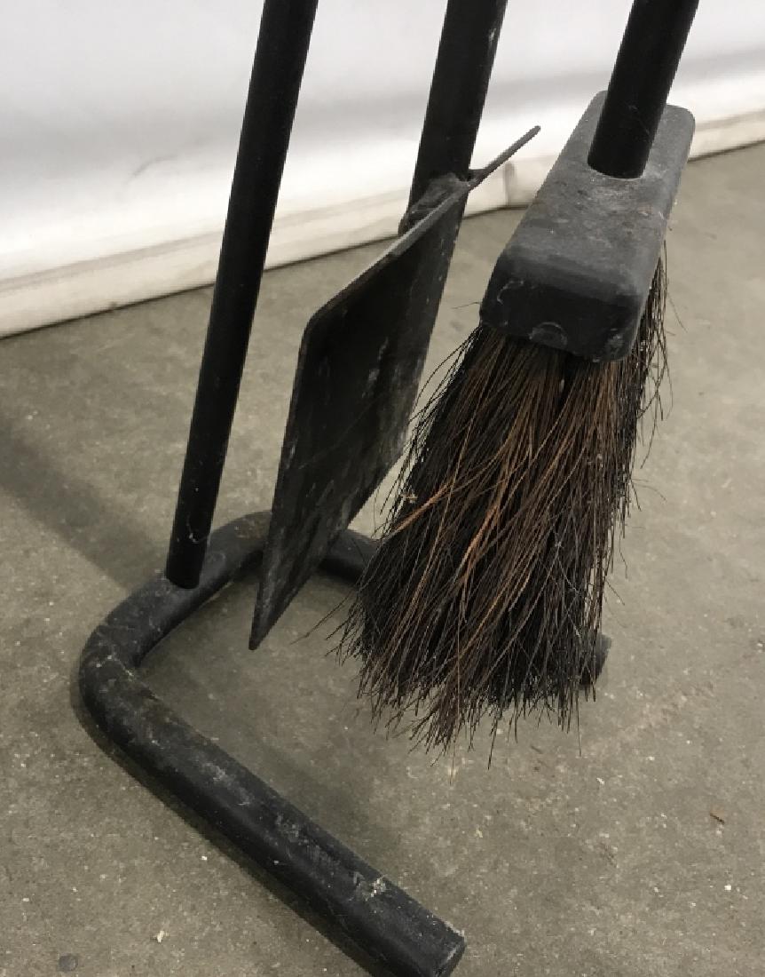Metal Fireplace Tools W Stand: Metal fireplace tools with stand, possibly cast iron metal. Tools include brush and scoop. Stand measures approx 24.5 inches in height by 6 inches in width by 6.5 inches in depth. Fireplace tools, fir