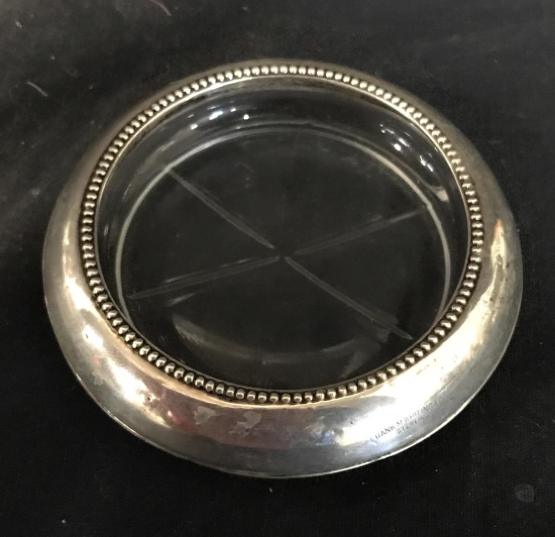 FRANK M WHITING & CO Sterling & Glass Coaster: Silver toned portion of piece reads FRANK M WHITING & CO Sterling. Remaining portion of Coaster is glass. Measures approx 4 inches wide .5 inhces tall. Coaster, trinket dish, tableware 6