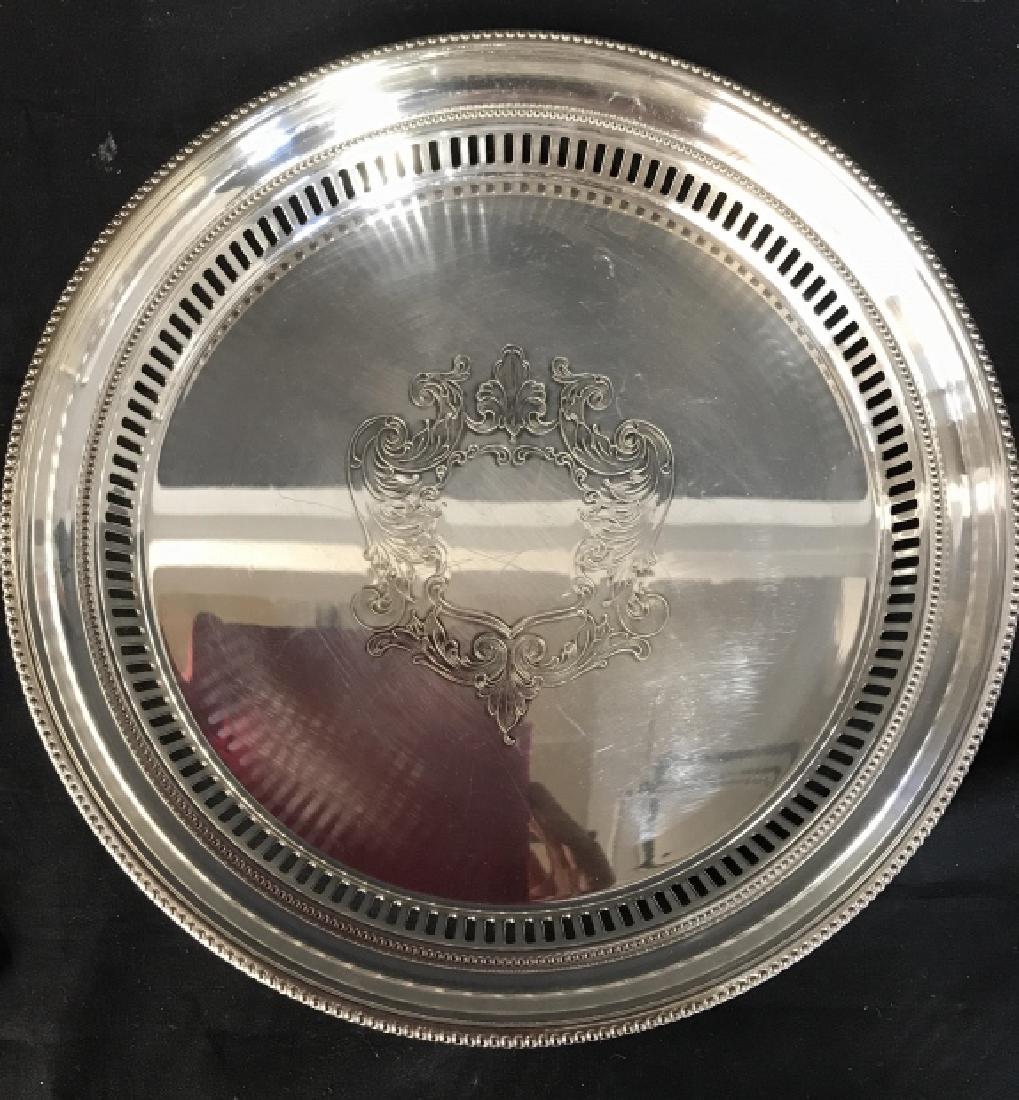 TOWLE Silver Toned Metal Tray: Underside is marked TOWLE. Center has ornate relief detail. Edges have pierced detail. Piece is circular. Measures approx 12 inches diameter 2 inches tall. tableware, tabletop accessory 6.