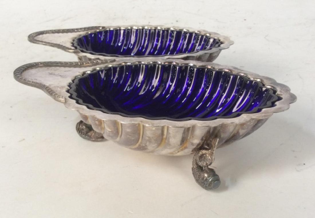 Pr William Adams Silver Plate w Blue Glass Shell: Servers , silver plate footed shell firm serving bowls, dishes, Tableware, with blue glass inserts, made in England, each marked, each measures app 2.5 inches ht length 7.5 inches width 7.5 inches, sc